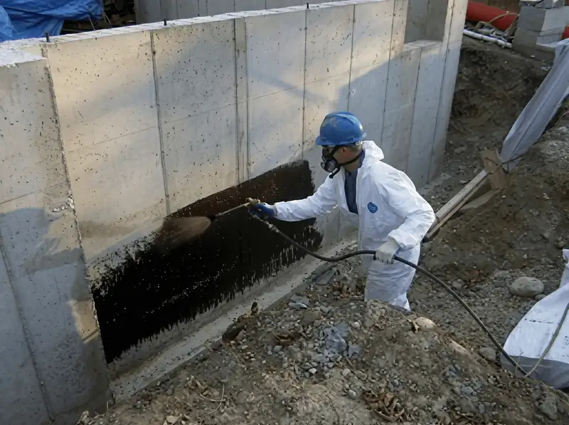 Professional waterproofing the exterior walls of the basement in Lowell, MA