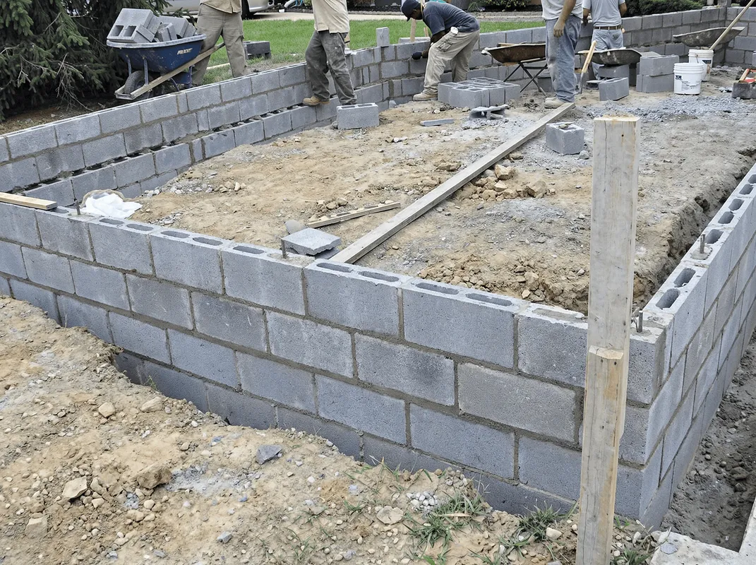 Professionals building a foundation with blocks in Lowell, MA