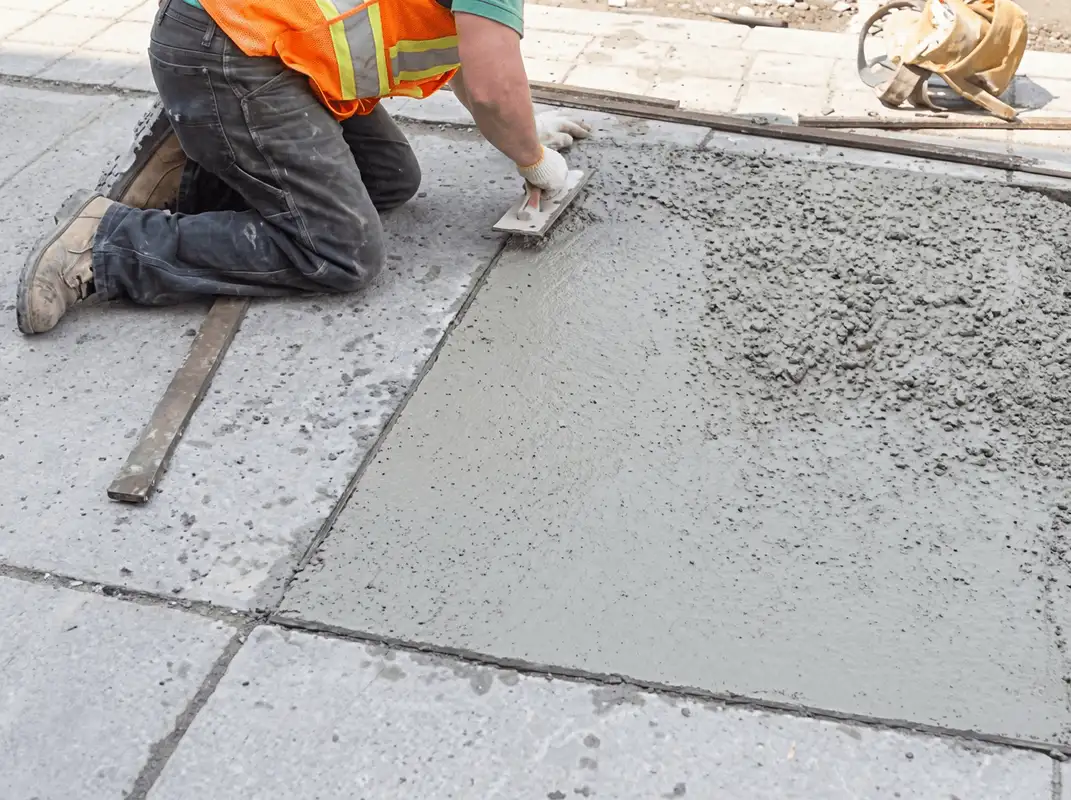 Professional repairing a concrete floor in Lowell, MA