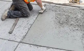 Professional repairing a concrete floor in Lowell, MA